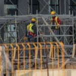 Photo by Boris Hamer: https://www.pexels.com/photo/men-in-helmets-working-on-scaffolding-on-building-site-14367420/